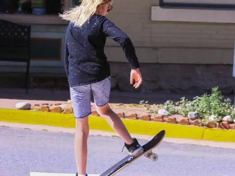girl on skateboard pushing