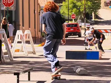 boy teen approching an parking block on skateboard